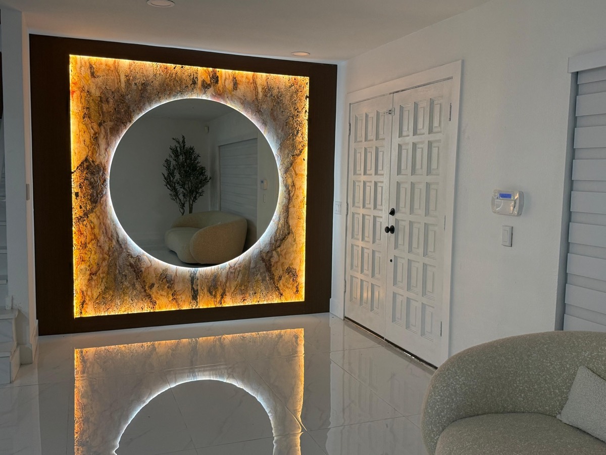 Backlit stone feature wall with a glowing halo mirror